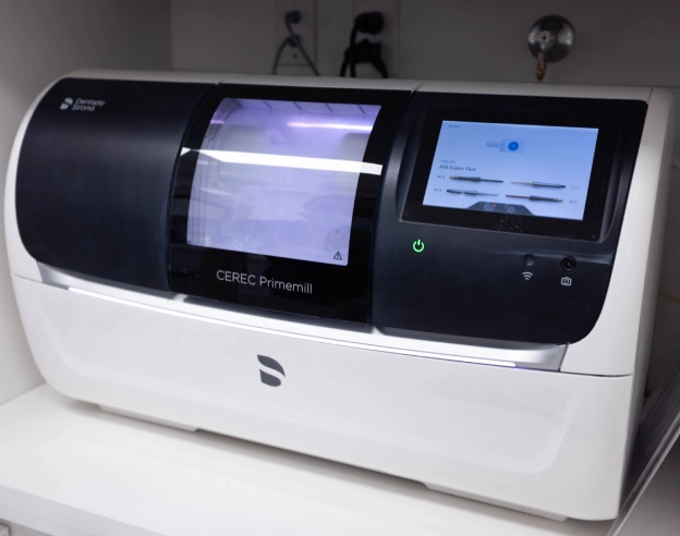 Modern dental laboratory analyzer machine with digital display screen in clinical setting.