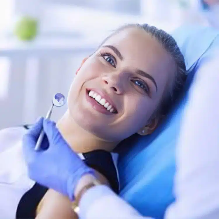 Happy patient in dental chair during checkup at Riggs Family Dental office