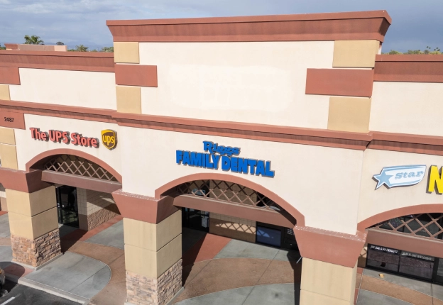 Exterior storefront of Riggs Family Dental office building with signage and entrance awning.