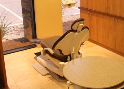 Dental chair and overhead light in modern treatment room at Riggs Family Dental office