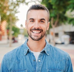 Patient smiling after receiving emergency dental care