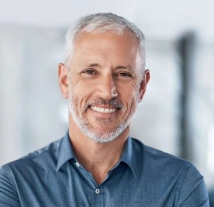 Patient smiling confidently with natural-looking dental implants