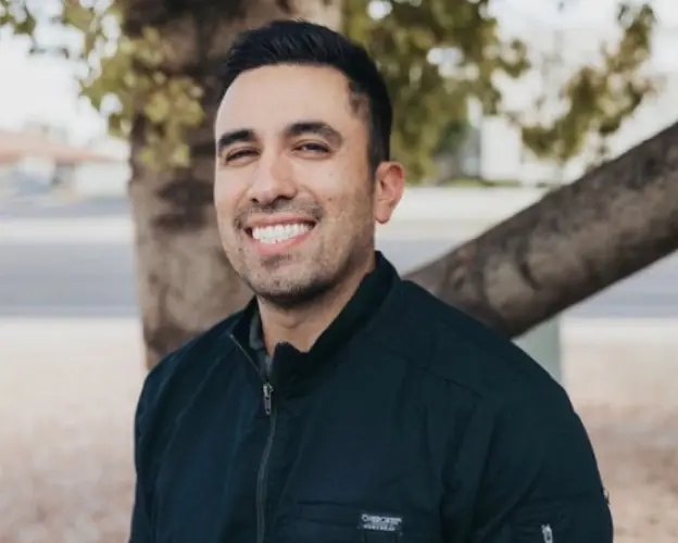 Dr. J. Andrew Andrino, dentist at Chandler dental practice, smiling outdoors.