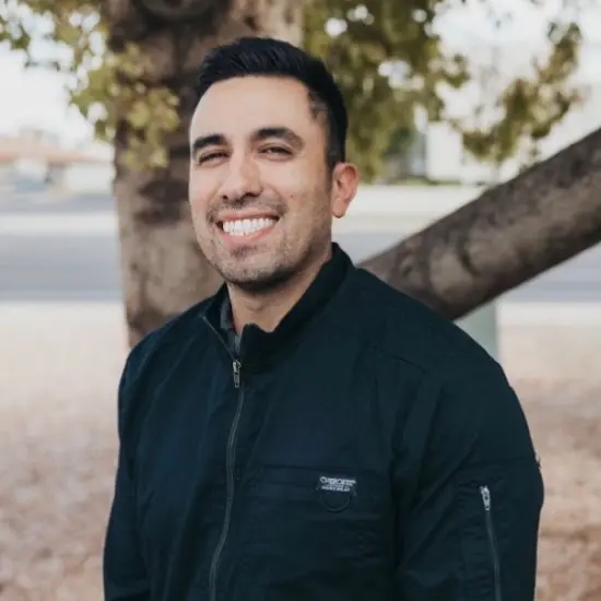 Dr. J. Andrew Andrino, dentist at Chandler dental practice, smiling outdoors.
